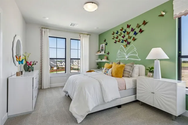 a bedroom with a bed table and a window