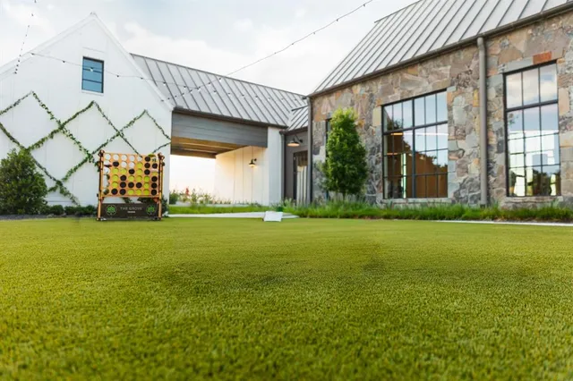 a view of a house with a garden and yard