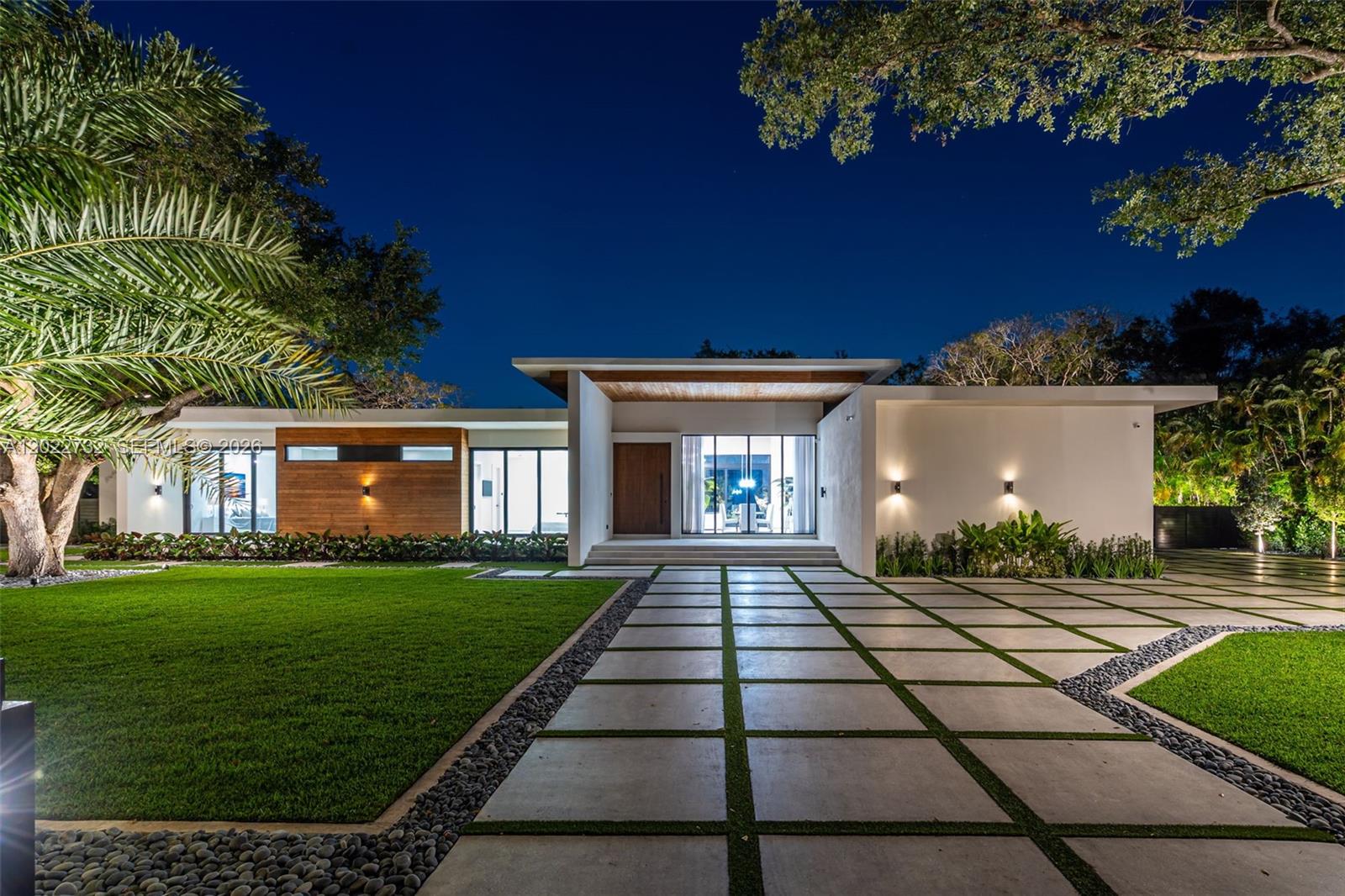 7825 Southwest 128th Street Pinecrest, FL 33156 - Photo 74 of 88 a front view of a house with a yard