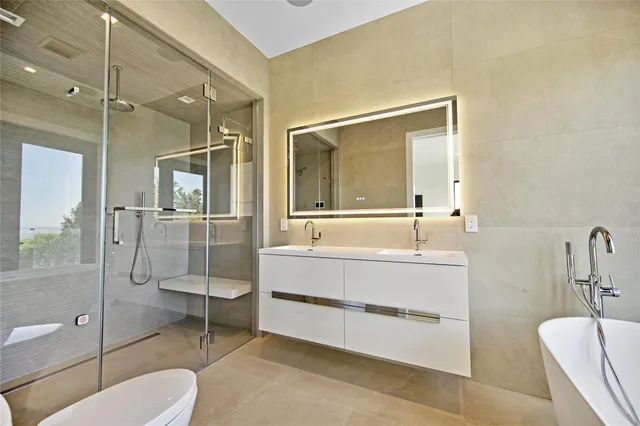 a spacious bathroom with a toilet sink and shower