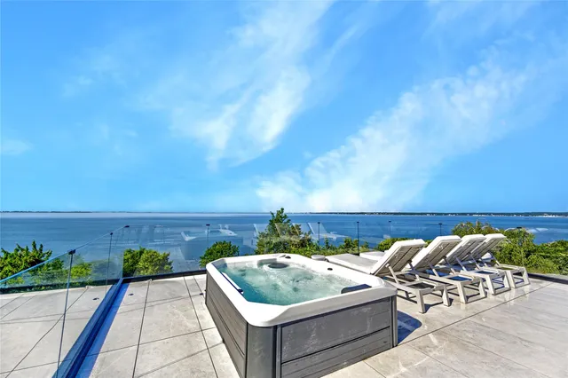 a view of roof deck with furniture and garden