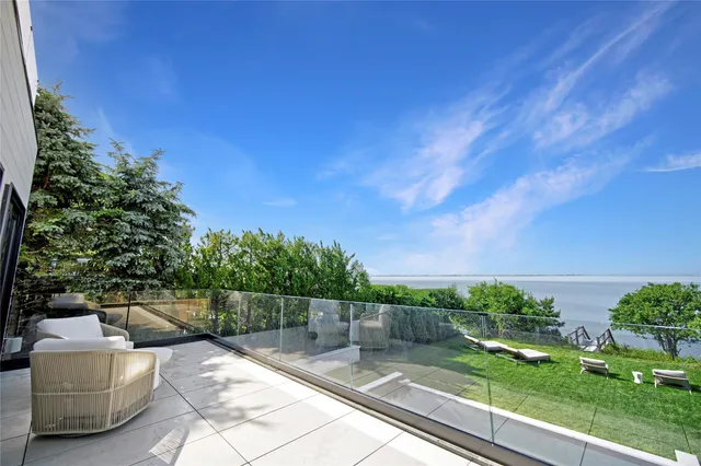 a view of a chair and tables in the balcony