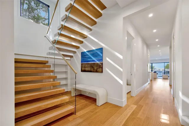 a view of entryway and hall with wooden floor