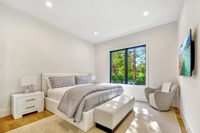 a bed room with a bed and a large window