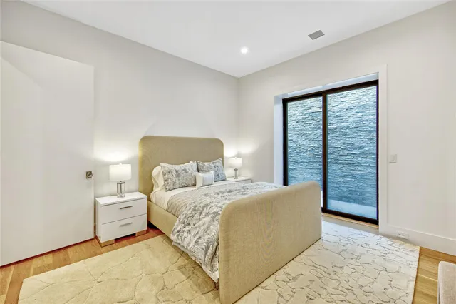 a bedroom with a large bed and a window