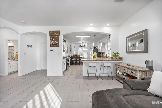 a living room with furniture and view of kitchen
