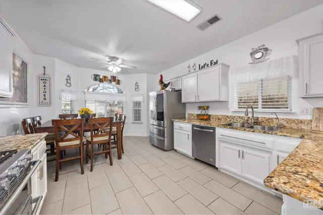 a kitchen with cabinets and chairs