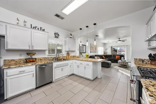 a kitchen with white cabinets and appliances