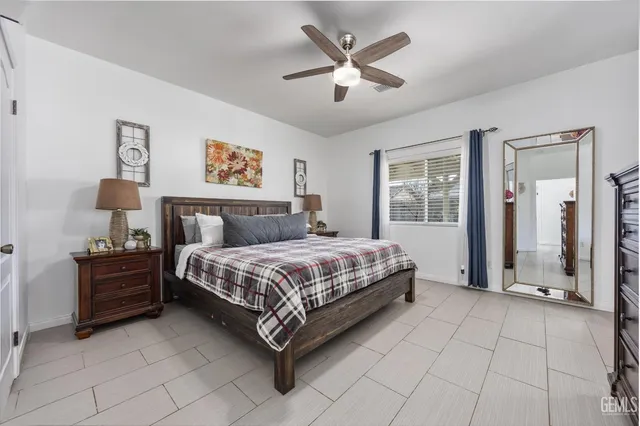 a bedroom with a large bed and a chandelier