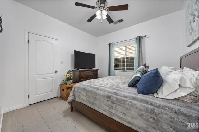 a bedroom with a bed and a flat tv screen