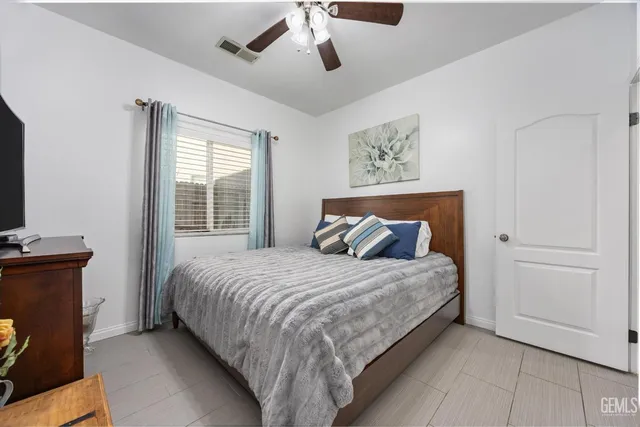 a bedroom with a bed and a flat tv screen