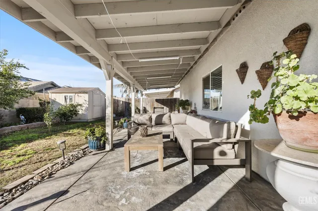 a view of a porch with furniture and garden