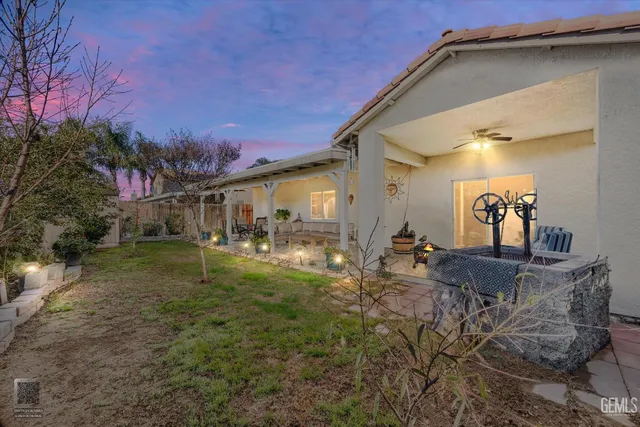 a backyard of a house with yard and outdoor seating