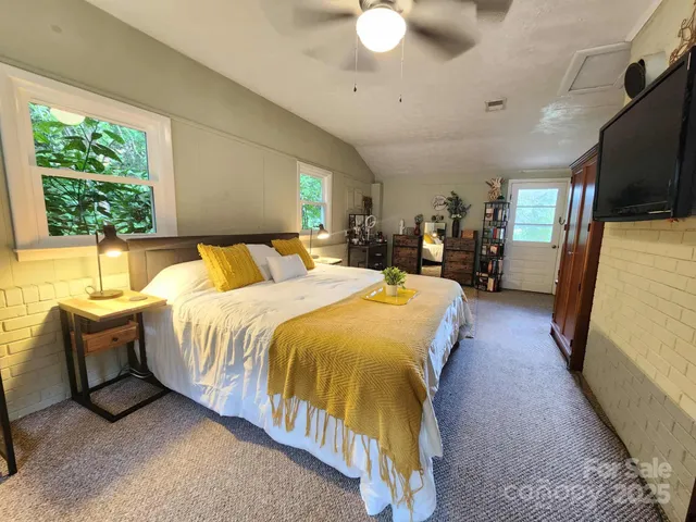 a bed sitting in a bedroom next to a window