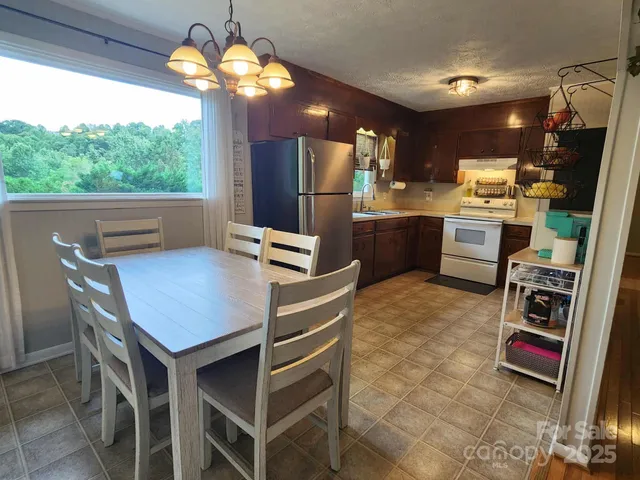 a kitchen with stainless steel appliances granite countertop a stove refrigerator and microwave