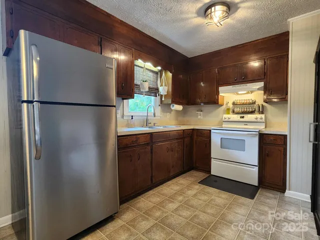 a kitchen with a refrigerator and a sink