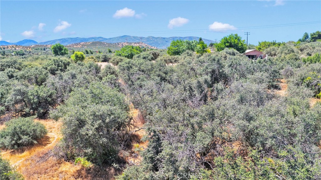 0 Sesame Road Oak Hills, CA 92344 - Photo 9 of 13 a view of a garden with a building in the background