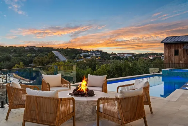 a view of a roof deck with couches and wooden floor