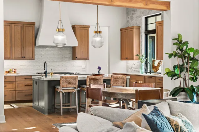 a spacious bedroom with a bed a chandelier and large window