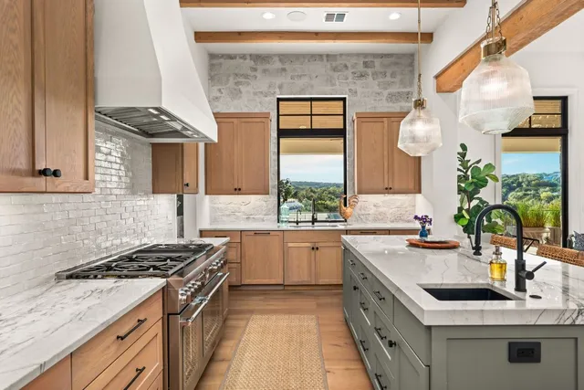 a kitchen with a stove sink and cabinets