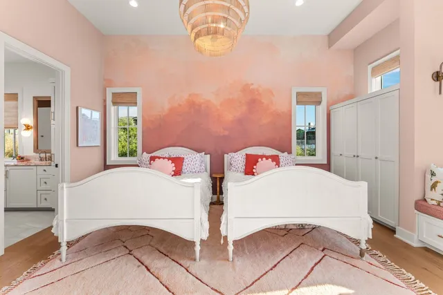 a bedroom with a bed and a chandelier