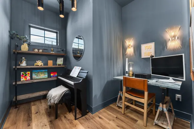 a view of a workspace with furniture and chandelier
