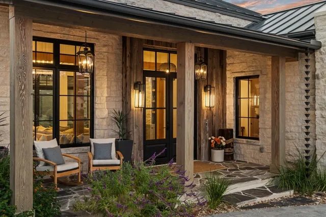 a view of a porch with a table and chairs and potted plants