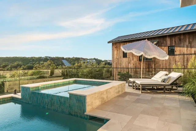 a view of a swimming pool with a lounge chair