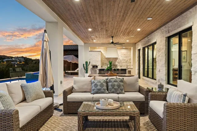 a living room with furniture a ceiling fan and a flat screen tv