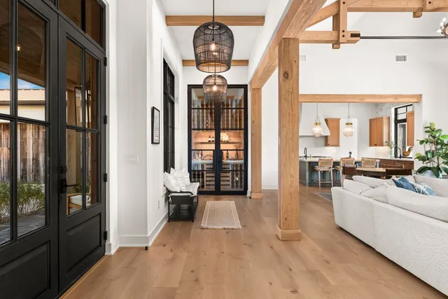 a living room with furniture a chandelier and a large window