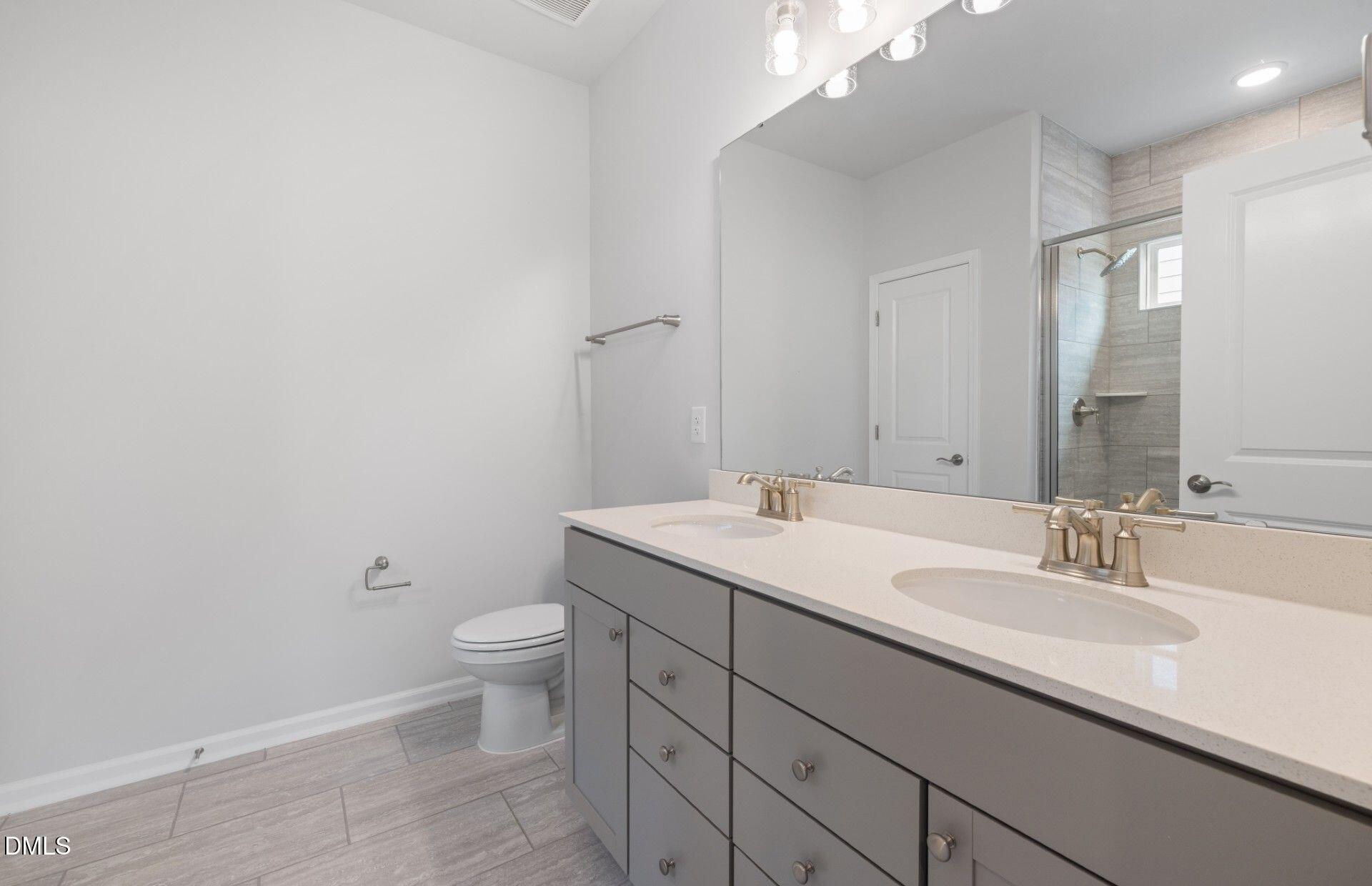 316 Broomside Avenue Raleigh, NC 27603 - Photo 12 of 31 a bathroom with a sink and a toilet