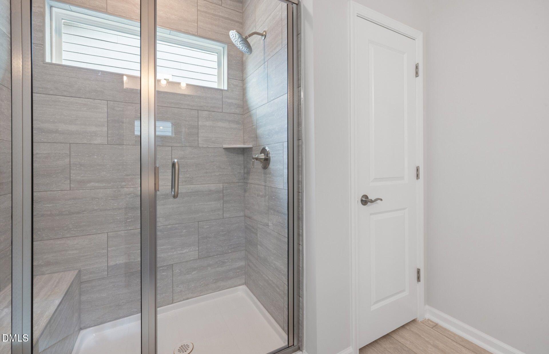 316 Broomside Avenue Raleigh, NC 27603 - Photo 13 of 31 a bathroom with a glass shower door