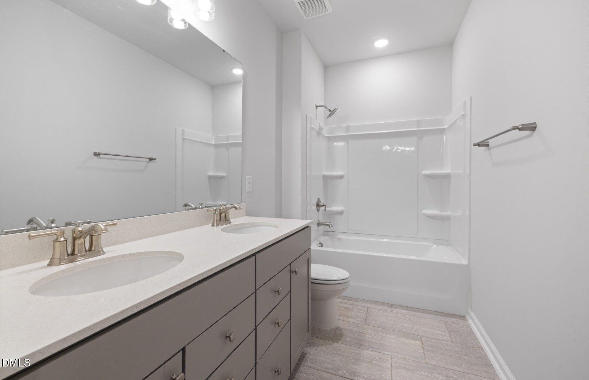 316 Broomside Avenue Raleigh, NC 27603 - Photo 16 of 31 a bathroom with a granite countertop sink a toilet and shower