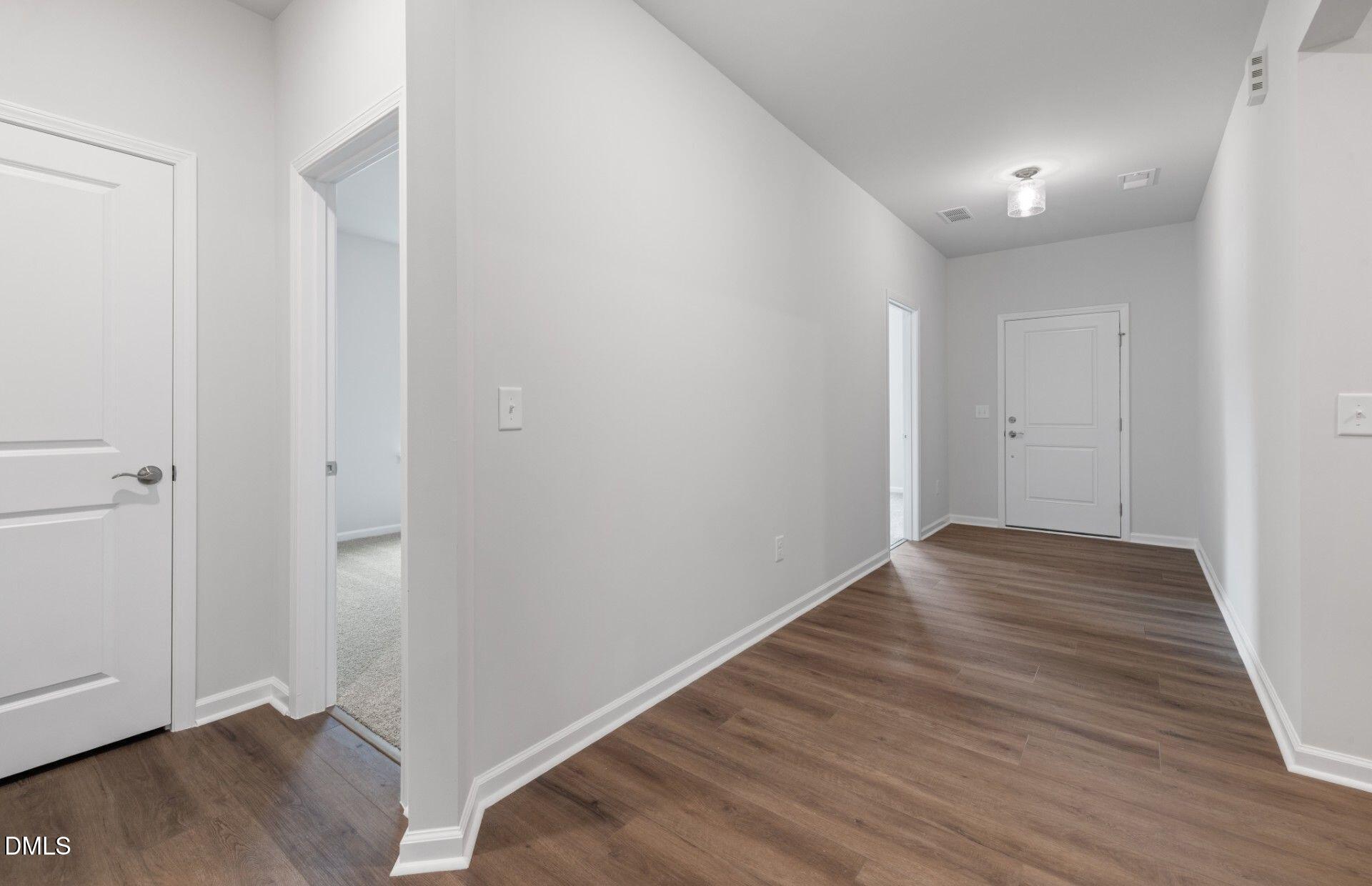 316 Broomside Avenue Raleigh, NC 27603 - Photo 19 of 31 a view of an empty room with wooden floor