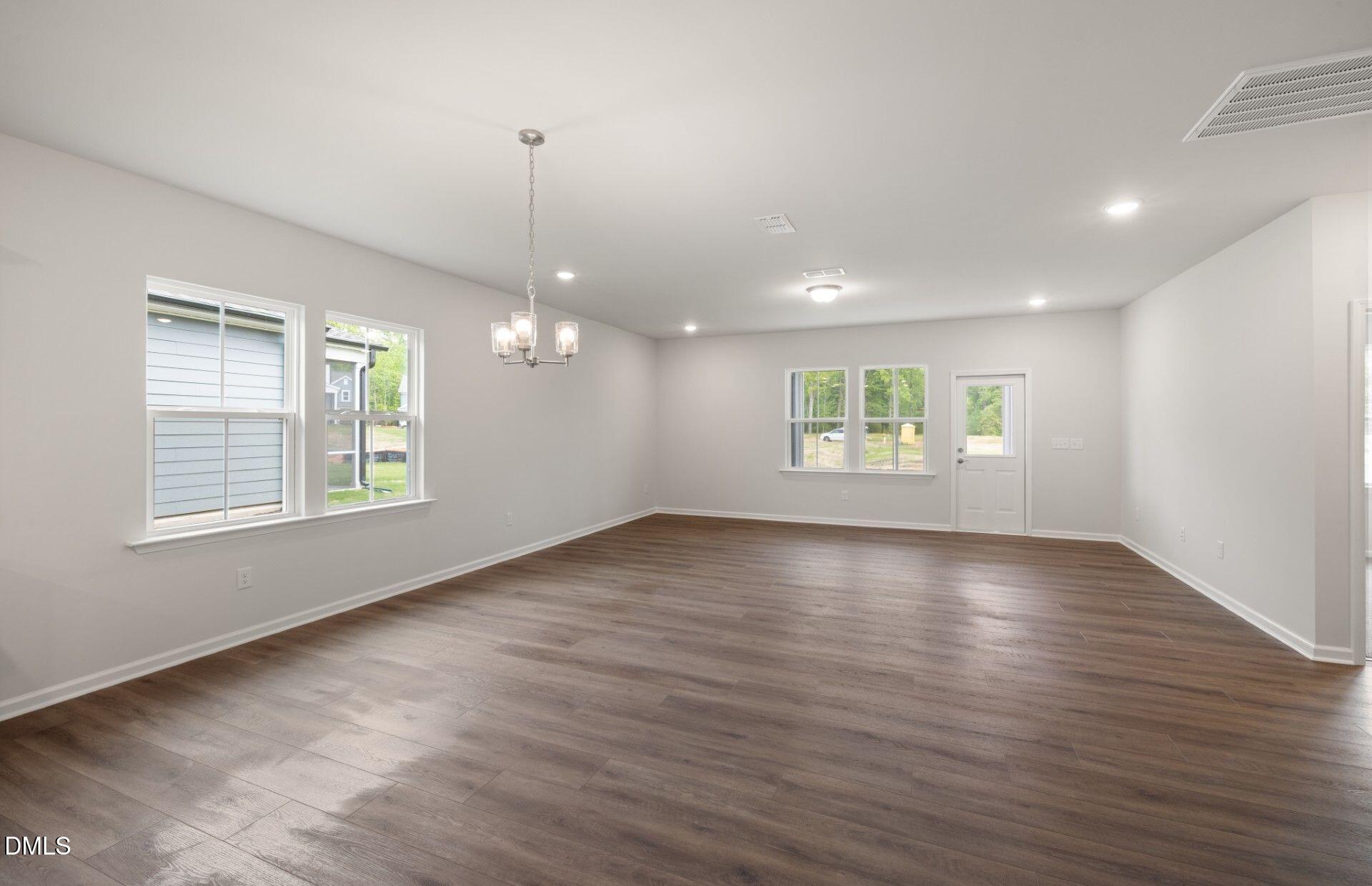 316 Broomside Avenue Raleigh, NC 27603 - Photo 5 of 31 an empty room with wooden floor and windows