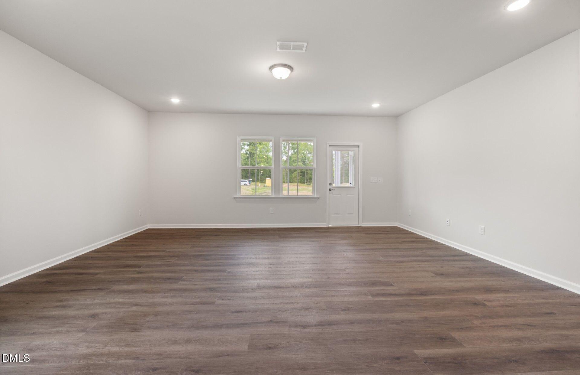 316 Broomside Avenue Raleigh, NC 27603 - Photo 7 of 31 a view of an empty room with wooden floor and window