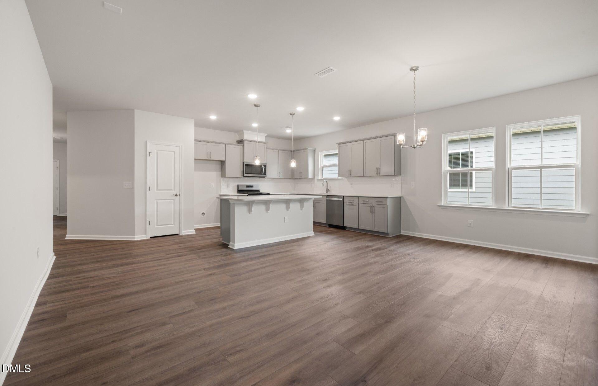 316 Broomside Avenue Raleigh, NC 27603 - Photo 9 of 31 a view of kitchen with wooden floor and window