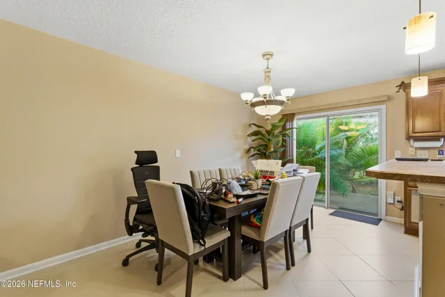a dining room with furniture a rug and a chandelier