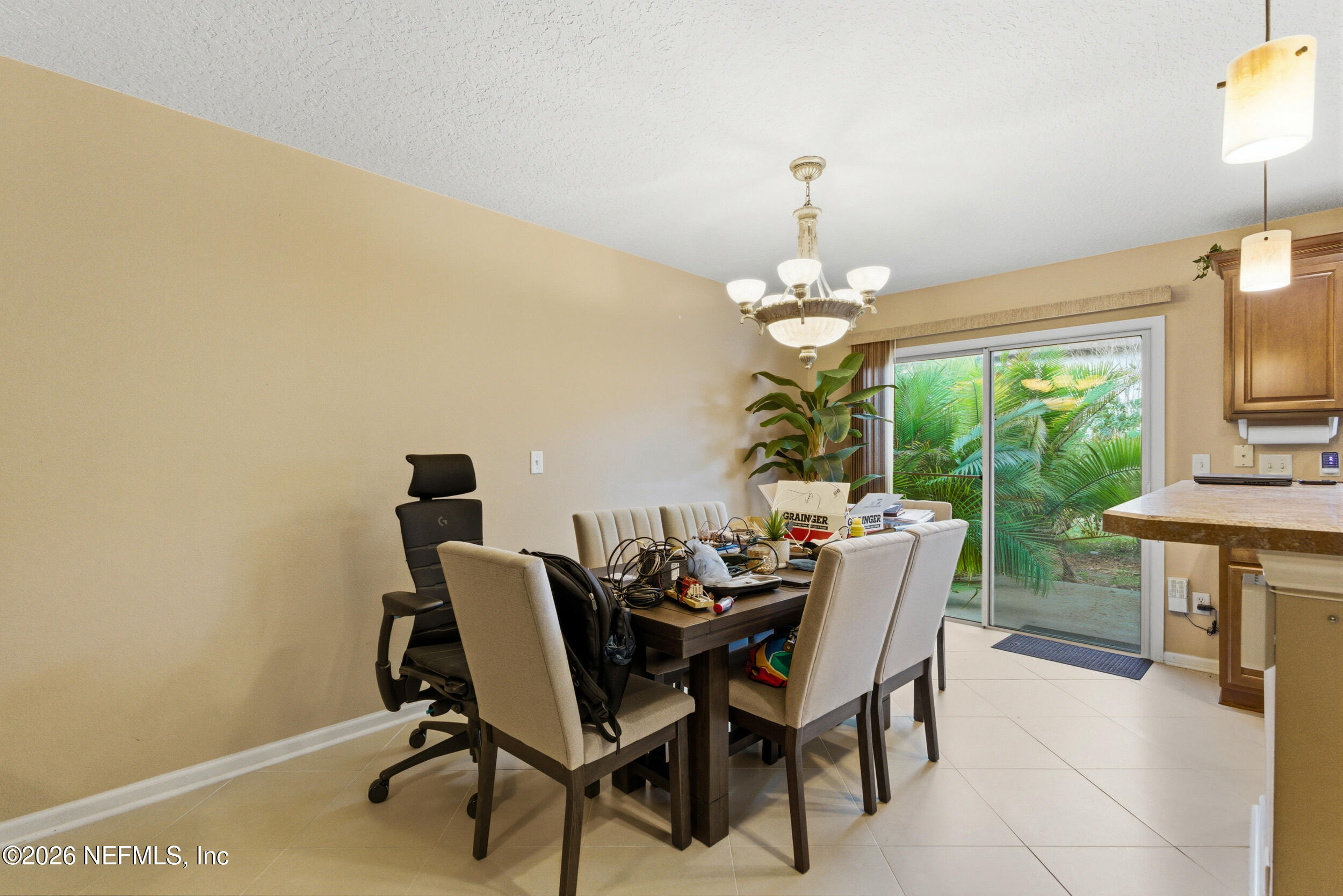 127 Crete Court St. Augustine, FL 32084 - Photo 11 of 33 a dining room with furniture a rug and a chandelier