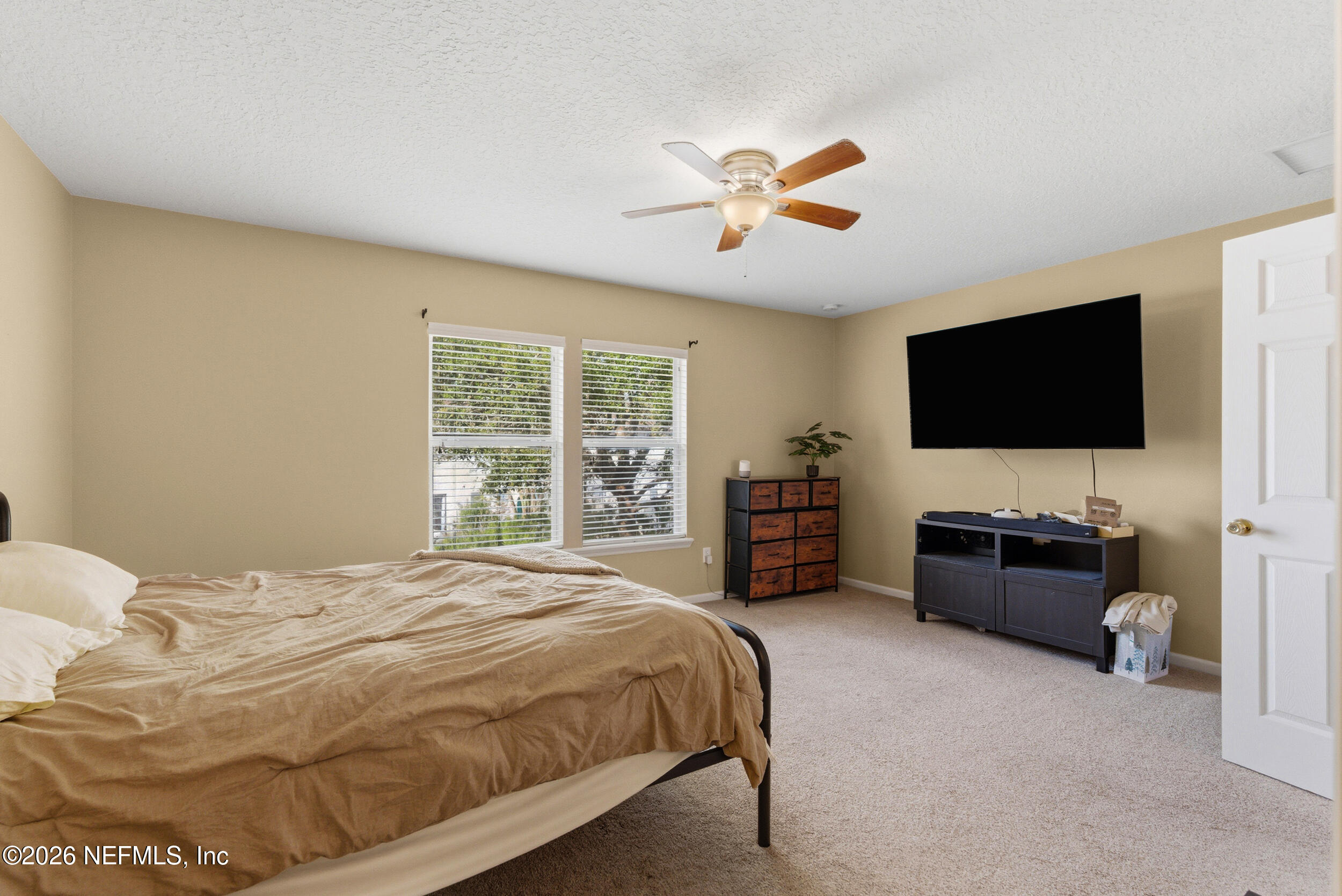 127 Crete Court St. Augustine, FL 32084 - Photo 17 of 33 a spacious bedroom with a bed and a flat screen television