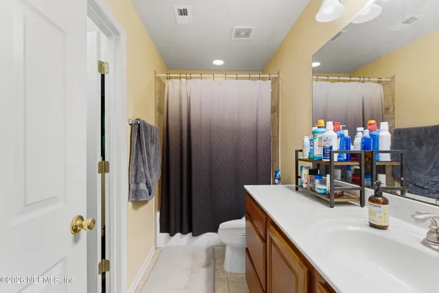 a bathroom with a sink vanity and a mirror