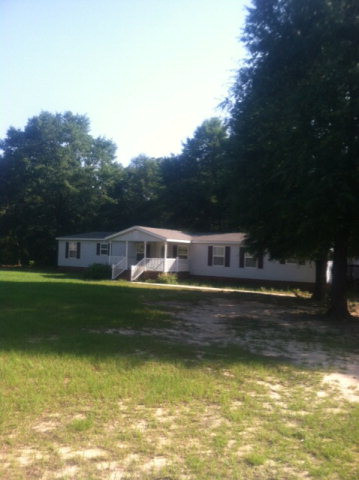a front view of a house with a large pool
