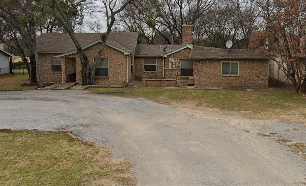 front view of a house with a dry trees