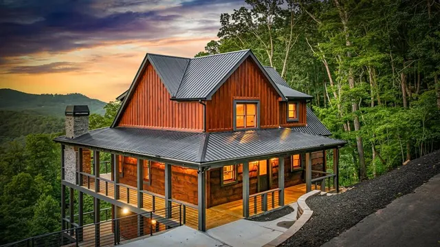 a view of house with a big yard and potted plants