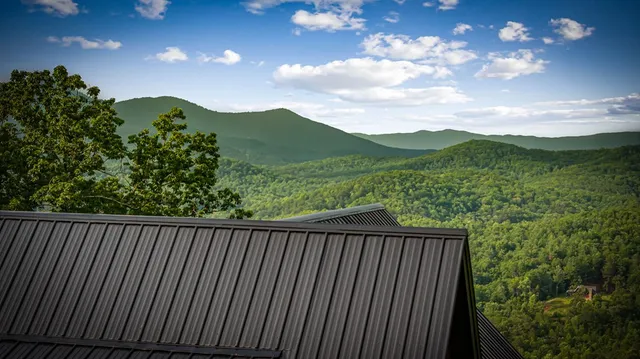 a kitchen with stainless steel appliances granite countertop a stove and a wooden floors