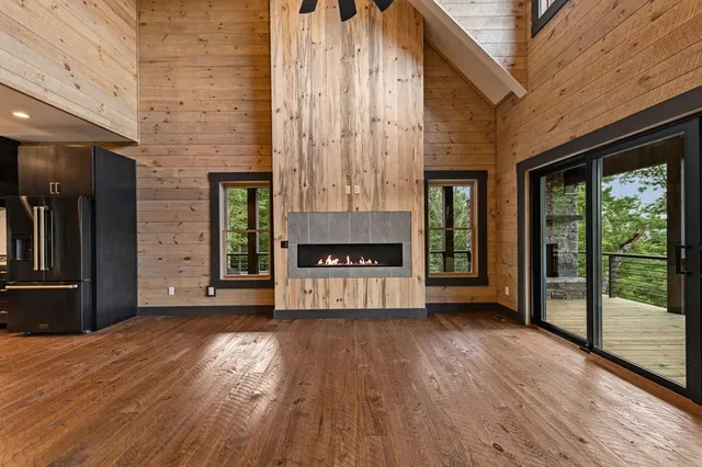 a bathroom with a granite countertop toilet a sink a mirror and a window
