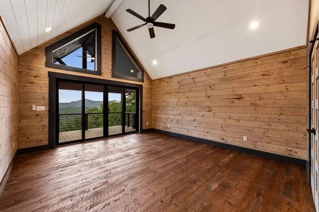 a bathroom with a tub a mirror and a shower
