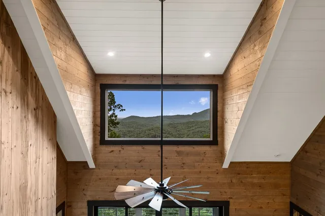 a view of balcony with wooden floor & fence