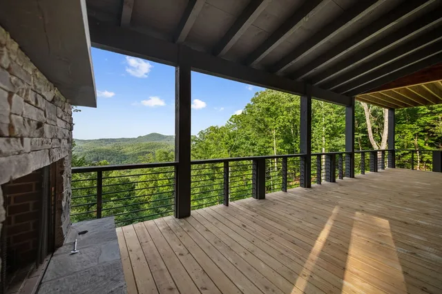 a balcony with wooden floor and outdoor space