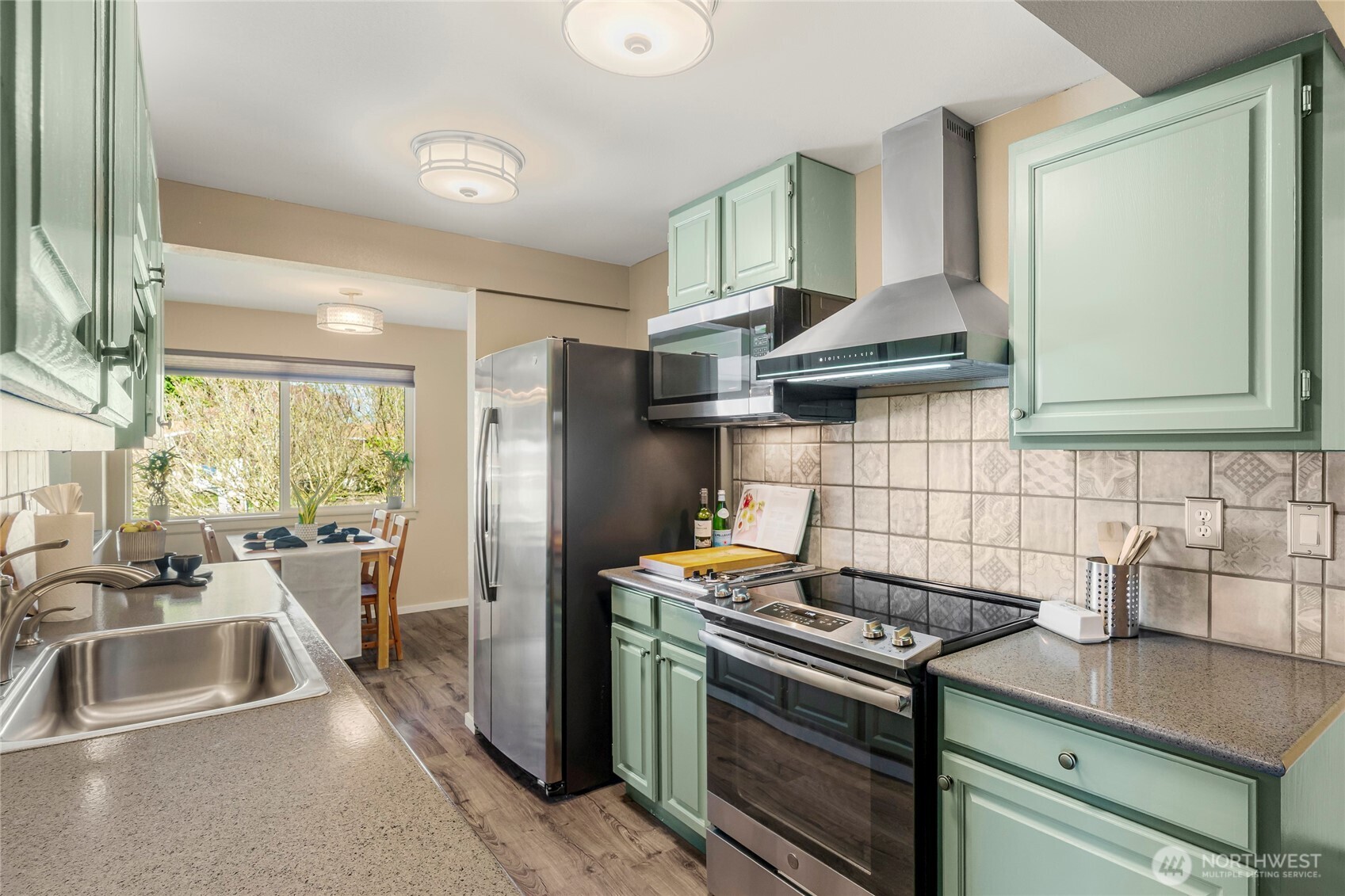 9537 South 213th Street Kent, WA 98031 - Photo 13 of 31 a kitchen with stainless steel appliances a stove a sink and a refrigerator